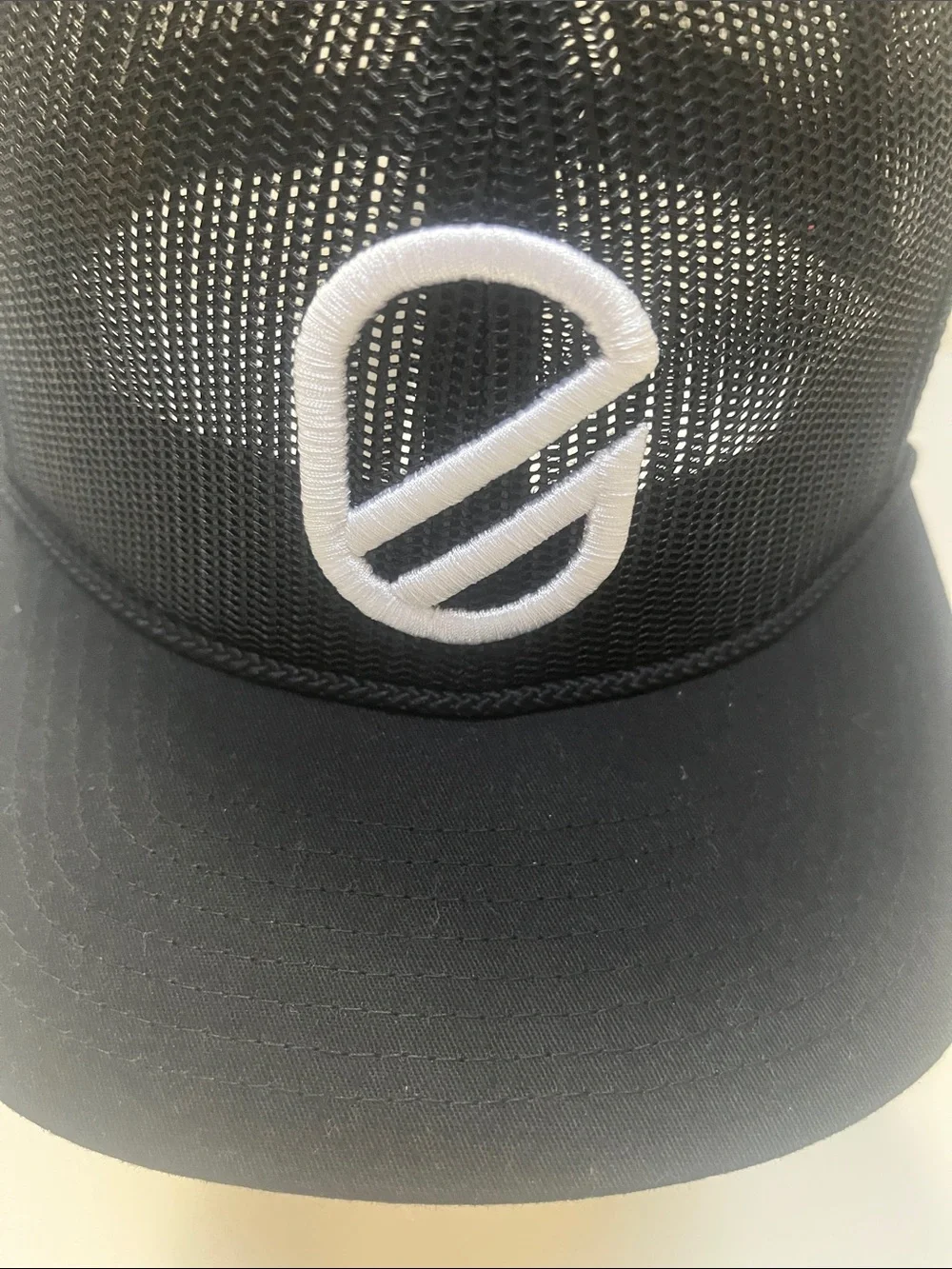 Extracurricular Black Mesh Trucker Cap with White Embroidered Logo